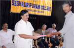 Presenting letter of offer of placement to a student of Seshadripuram College as Hon. General Secretary of Seshadripuram Educational Trust.  Principal Dr. Narahalli Balasubramanya looks on