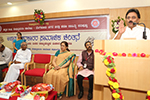 Educationist Dr. Wooday P. Krishna addressing a State Level Seminar on 'Social Thoughts of less known Vachanakaras' organized by Seshadripuram College, 2016. Noted Folklorist Dr. Go. Ru. Channabasappa, Principal Dr. Anuradha Roy and Prof. Notkar Satish are seen.