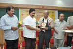Felicitating Dr. Sashidhar Buggi, Secretary, Karnataka State Tuberculosis Association on the occasion of T. B. Seals Campaign under the auspicious of Youth Red Cross Unit of Seshadripuram College, Bengaluru, 2013.